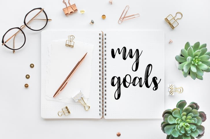 a journal with my goals written on a page