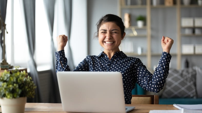 a young woman celebrating success